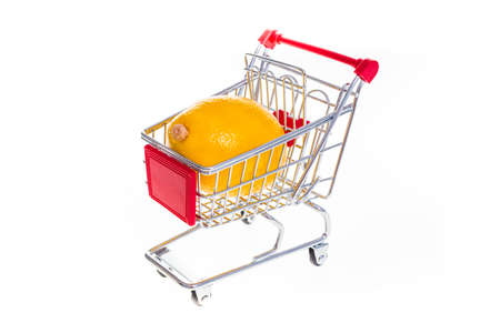 Lemon in shopping cart isolated on white backgroundの写真素材