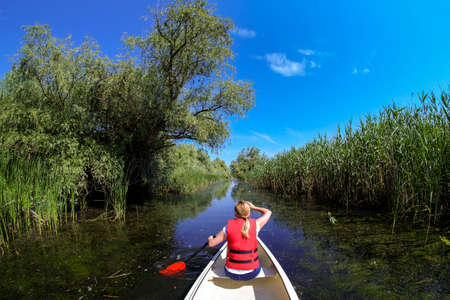 Exploring Danube Delta in Canoe Boatの写真素材