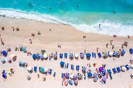 Egremni Beach Lefkada tourists relaxing on the beach, swimming and playing games on a hot summer dayの写真素材