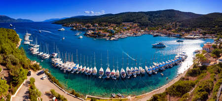 Yachts ancored in harbour in Fiskardo Kefalonya bay in Greeceの写真素材