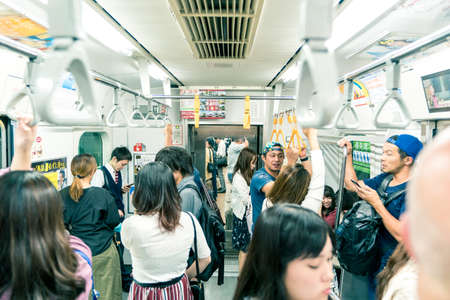 Tokyo, Japan, October 2017: People on subway train in Tokyo City, Japanのeditorial素材