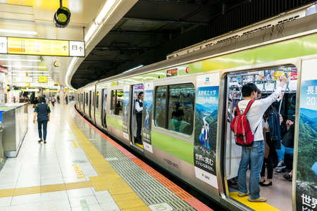 Tokyo, Japan, October 2017: Tokyo subway station and train. People riding the subway at rush hourのeditorial素材