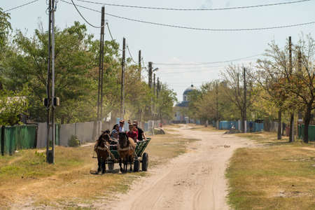 Letea, Danube Delta, August 2017: Peasants traveling with a cariage in the Letea traditional fishing village in Delta Dunarii, Romania1のeditorial素材