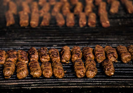 Grilled minced meat rolsls called Mici in traditional Romanian cuisine