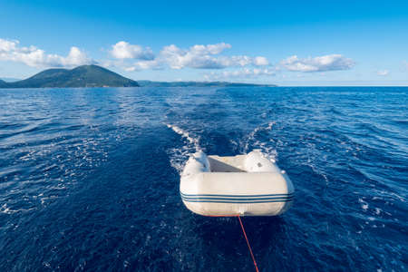 Dinghy (or dingey) inflatable small boat towed by a yacht in the Mediterranean seeaの写真素材