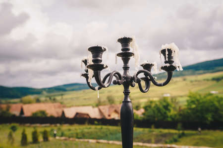 Vintage candle holder with melted wax from burned candlesの写真素材