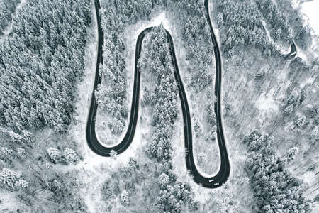 Bending road in the forest in winter timeの写真素材