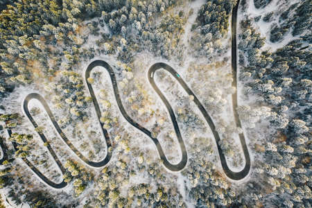 Foggy winter morning above a mountain road after a snowfall