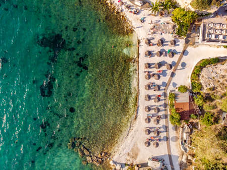 Greek Beach with sand and clear blue water top down aerial view shot using a droneの写真素材