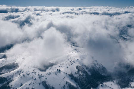 Romania above the clouds. Severe snowy weather in winter timeの写真素材