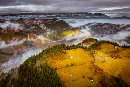 Aerial view over Transylvania on a cold foggy morning in the Rucar Bran Pass