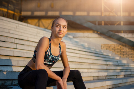 Woman in sportswear taking rest after trainingの写真素材