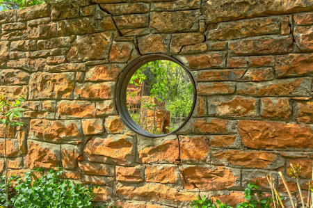 View through a round window of the only remaining wall of the Mayhew Lodge in the Call Of The Canyon recreational area. Built in 1870 near Oak Creek Arizona.の写真素材