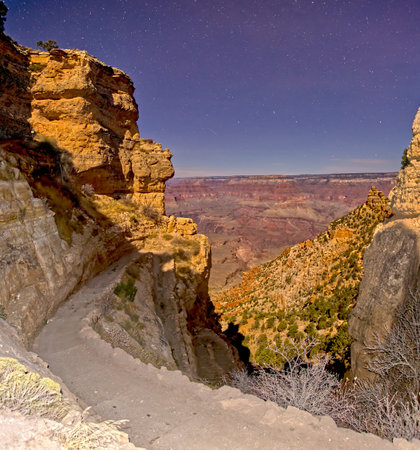 Grand Canyon at night from the upper South Kaibab Trail. Flash was used for the foreground. The cliffs and canyon is lit by moonlight.の写真素材