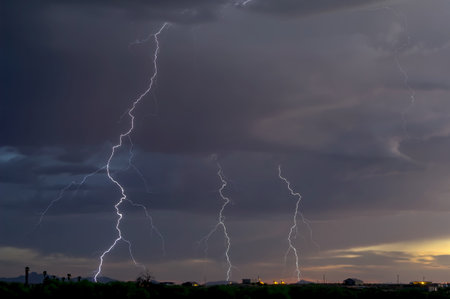 Three lightning bolts striking near sundown during an Arizona monsoon storm.