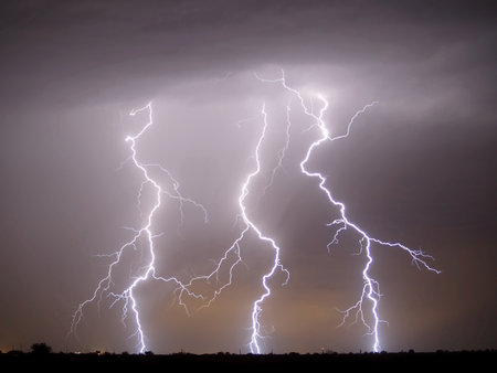 Three bolts of lightning striking in Arlington Arizona during the 2007 Monsoon season.