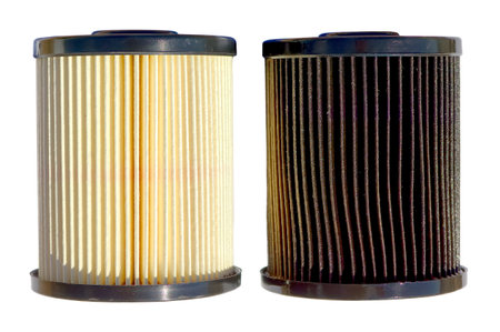 A clean and fresh out of the box diesel fuel filter on the left in contrast with an old and dirty filter on the right. The dirty filter had only 15,000 miles of use. This illustrates just how dirty and contaminated diesel fuel can be. If the filter is not replaced periodically it can become so clogged that the engine will stall from fuel starvation.の写真素材