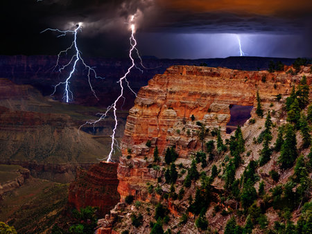 An HDR composite photo of day and night at Cape Royal north rim Grand Canyon. The lightning was taken at night. The canyon landscape was taken during daylight. Because these colors cannot be seen by the unaided eye at the time of the photography this is considered an artistic composition.の写真素材
