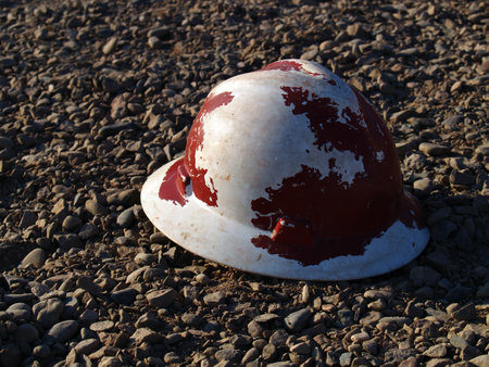A construction hard hat left lying on gravel, probably forgotten by a construction worker at a construction site in Arlington AZ.の写真素材