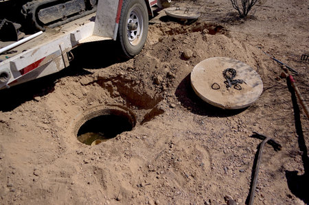 A septic tank with its lids uncovered in preparation of having the waste inside pumped out.