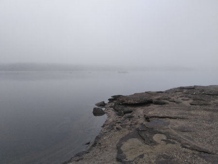 The mist. The stony bank of the river in a gray haze. Late Autumn. Gloomy moodの写真素材