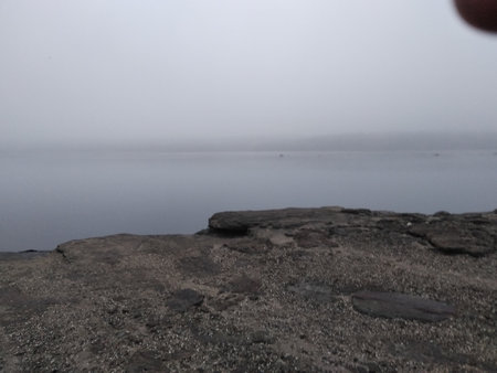 The mist. The stony bank of the river in a gray haze. Late Autumn. Gloomy moodの写真素材