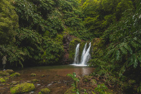 Waterfalls in Azores always provide a very high contrast against the lush greens of the island. They can be found in many places as Azores has many hills and steep terrain created by volcanic activity, shaping the land in a way that creates cascades, waterfalls, and hot springsの写真素材