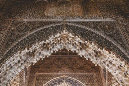 Granada, Spain - 5/6/18: Intricate sculpted window details of moorish arabian origin / influence. Ancient arch windows. Nasrid dynasty Palace of the Lions, Alhambra.のeditorial素材