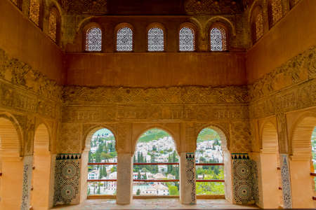 Granada, Spain - 5/6/18: Intricate sculpted window details of moorish arabian origin / influence. Ancient arch windows. Nasrid dynasty Palace of the Lions, Alhambra.のeditorial素材