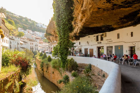 Setenil de las Bodegas, Spain - 5/10/18: Buildings constructed under big rock natural formations in Setenil de las Bodegas. Houses and shops are carved into the rock, providing natural cooling.のeditorial素材