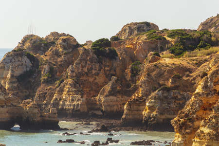 D. Ana Beach, Lagos Portugal. Rocky landscape, beautiful high cliffs with many small stone shore...