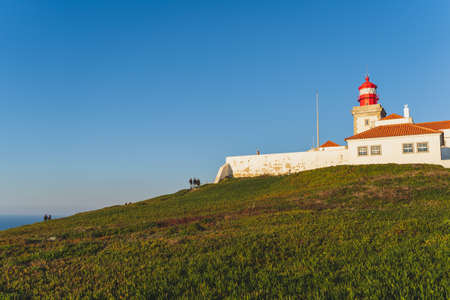 Cape Roca lighthouse (Cabo da Roca) Green grass, blue sky and atlantic ocean, Westernmost extent of continental Europe and the Eurasian land mass.の写真素材