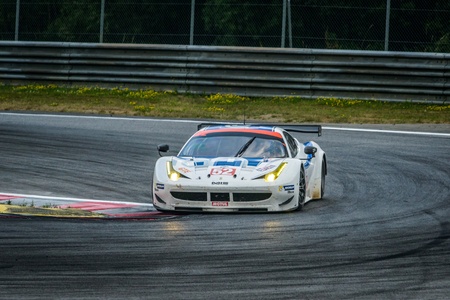 SPIELBERG, AUSTRIA - JULY 20 Johnny Mowlem of  	Ram Racing team on Ferrari F458 Italia participates in a rally for European Le Mans Series on July 28, 2013 in Spielberg, Austriaのeditorial素材