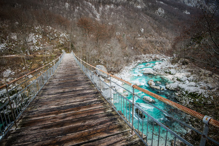 Hanging bridge over turquoise Soca river in the Triglav National Park in Slovenia.