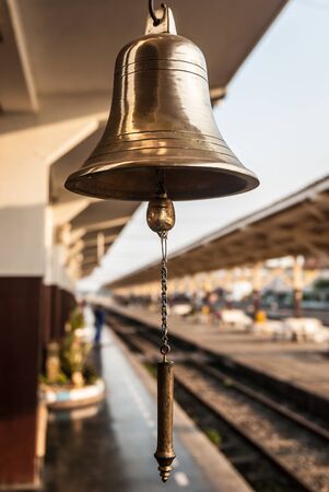 Closeup of a brassy bell at Thailand\'s train station.の写真素材