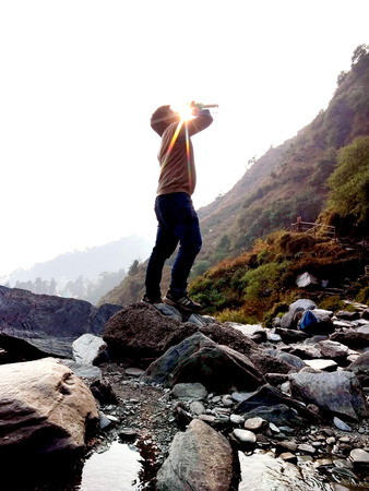 A Boy Drinking Water In Mountain