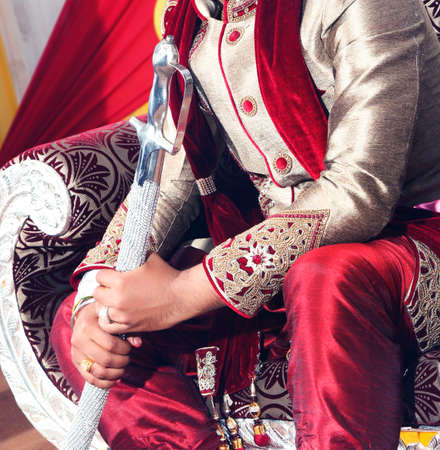 Indian Groom sitting at wedding stage on sofaの写真素材