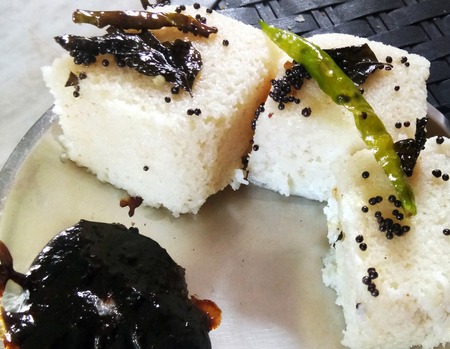 Indian gujarati Traditional Street Food Khaman Dhokla snack made from chick pea flour and rava Served With sev and Chilliの写真素材