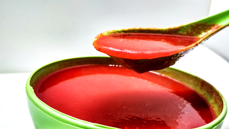 Tomato soup in a bowl isolated on white backgroundの写真素材