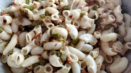 Elbow macaroni pasta with tomatoes, beans and parmesan on a plate close-up on the table. Horizontalの写真素材