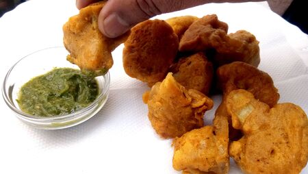 Vegetable pakora,Cauliflower pakora,served hot indian snack,served along with tomato ketchup,green chilly,の写真素材
