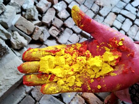 Female hands holding dry color powder
