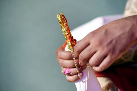 Indian groom holding a wedding knife kirpanの写真素材