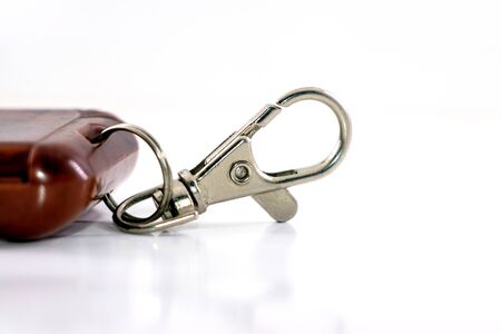 Closeup shot of a carabiner on a trinket isolated on a white backgroundの写真素材
