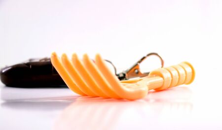 Closeup shot of a yellow plastic fork isolated on a white backgroundの写真素材