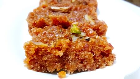 Homemade carrot halwa, traditional indian sweet, on white plateの写真素材