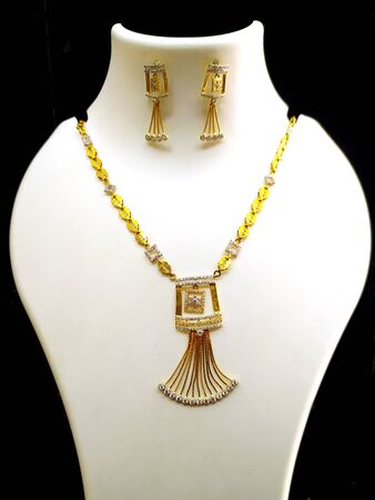 Gold necklaces on necklace display stand.の写真素材