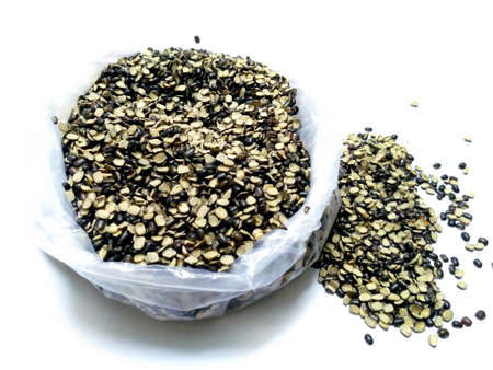 Split Black Lentil Also Know as Black Gram, Black Urad Dal, Vigna Mungo, Urad Bean, Urad Dal, Minapa Pappu, Mungo Bean or Black Matpe Bean Isolated on White Backgroundの写真素材