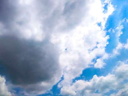 Bright blue sky background with cloudsの写真素材