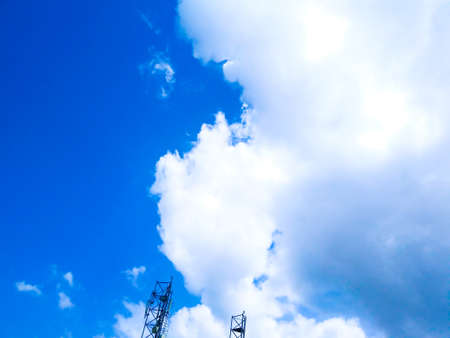 Bright blue sky background with cloudsの写真素材